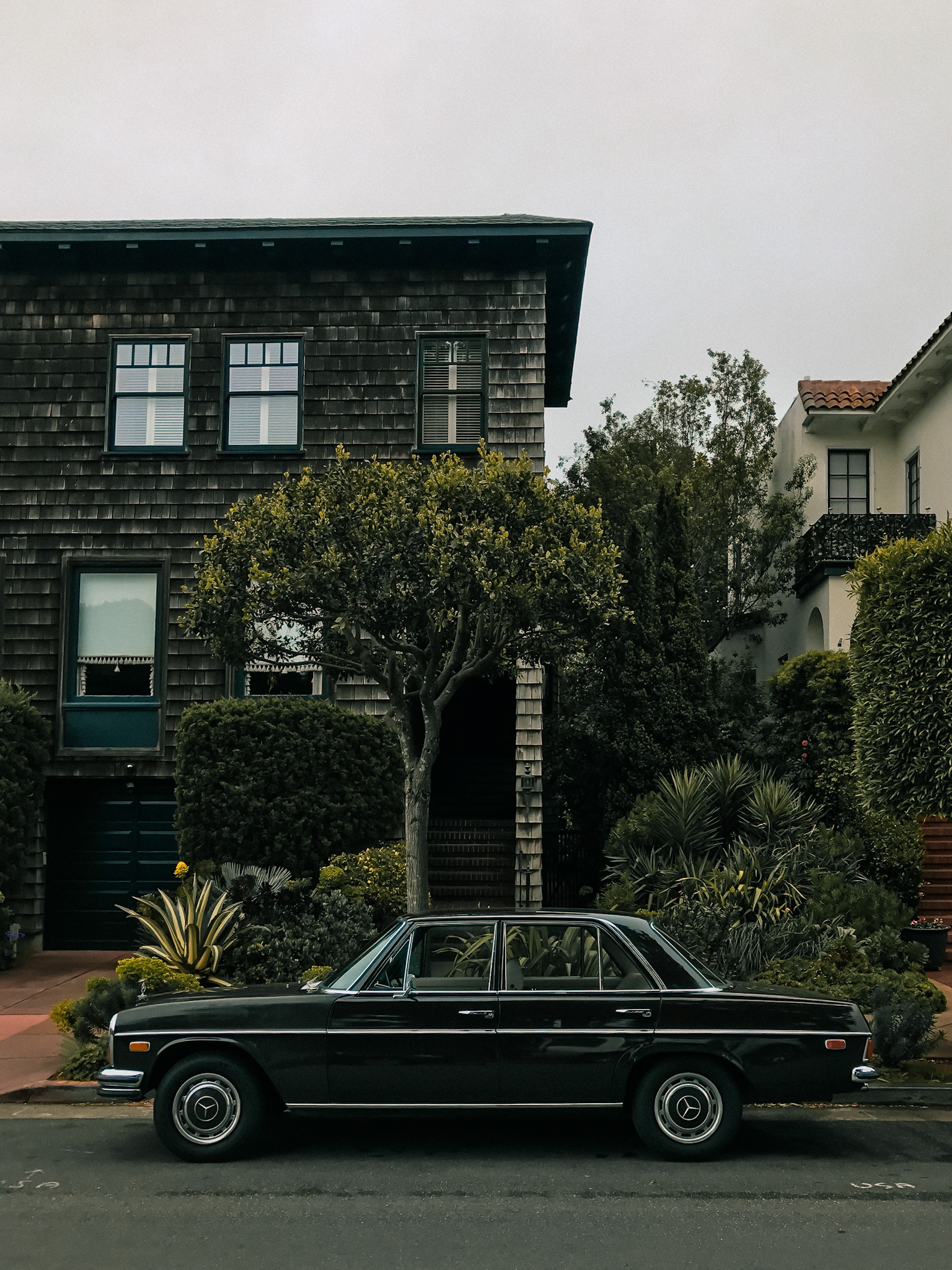 Vintage Mercedes sedan parked on a residential street in San Francisco