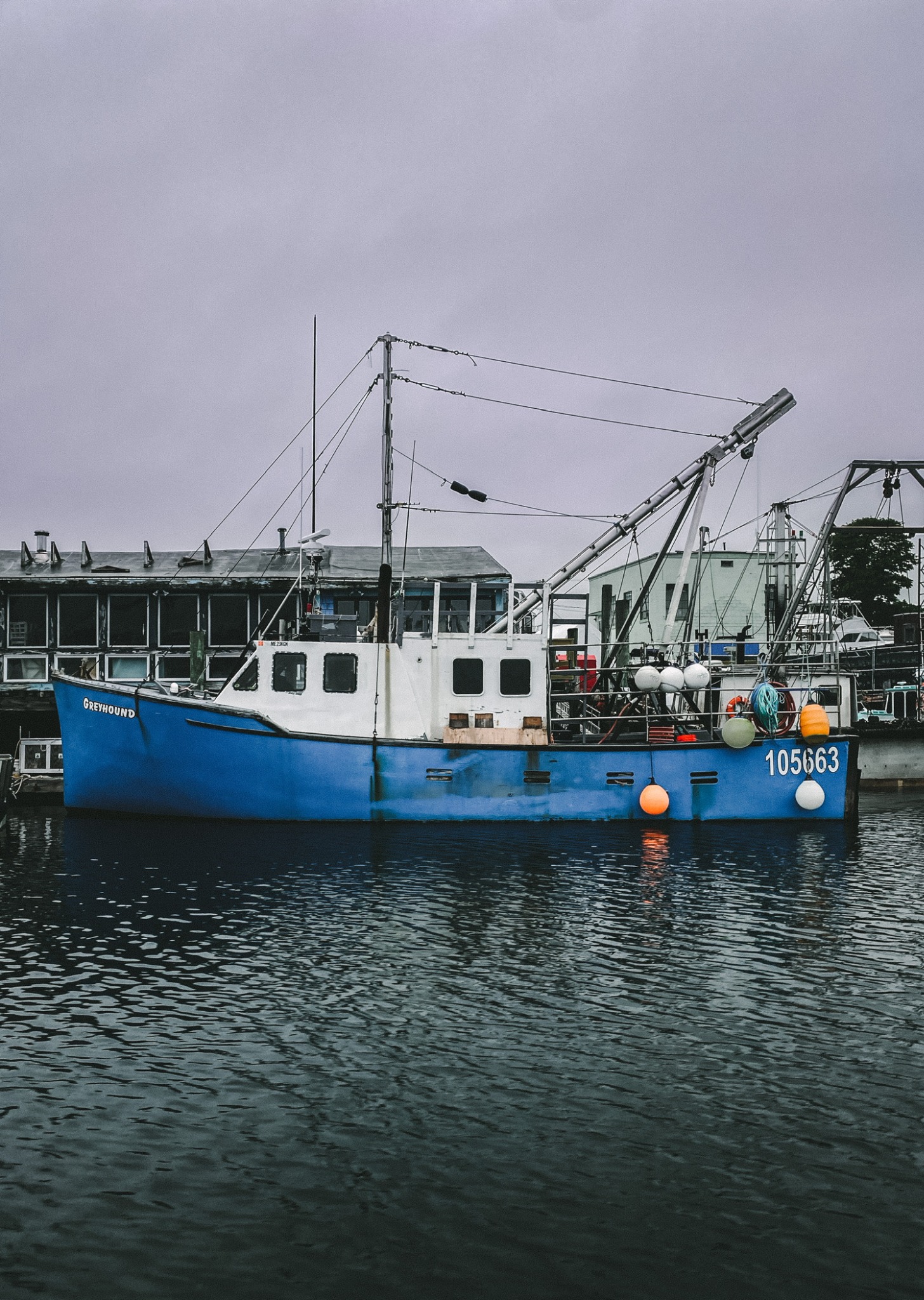Blue commercial fishing boat in Gloucester, Massachusetts harbor