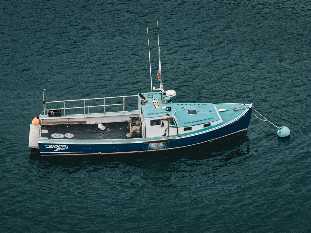 Aerial photograph of the Shooting Star lobster boat moored alone in Beverly Harbor Massachusetts winter